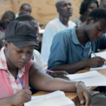 Students doing their classwork in a local community school in Cite Soleil, Haiti.